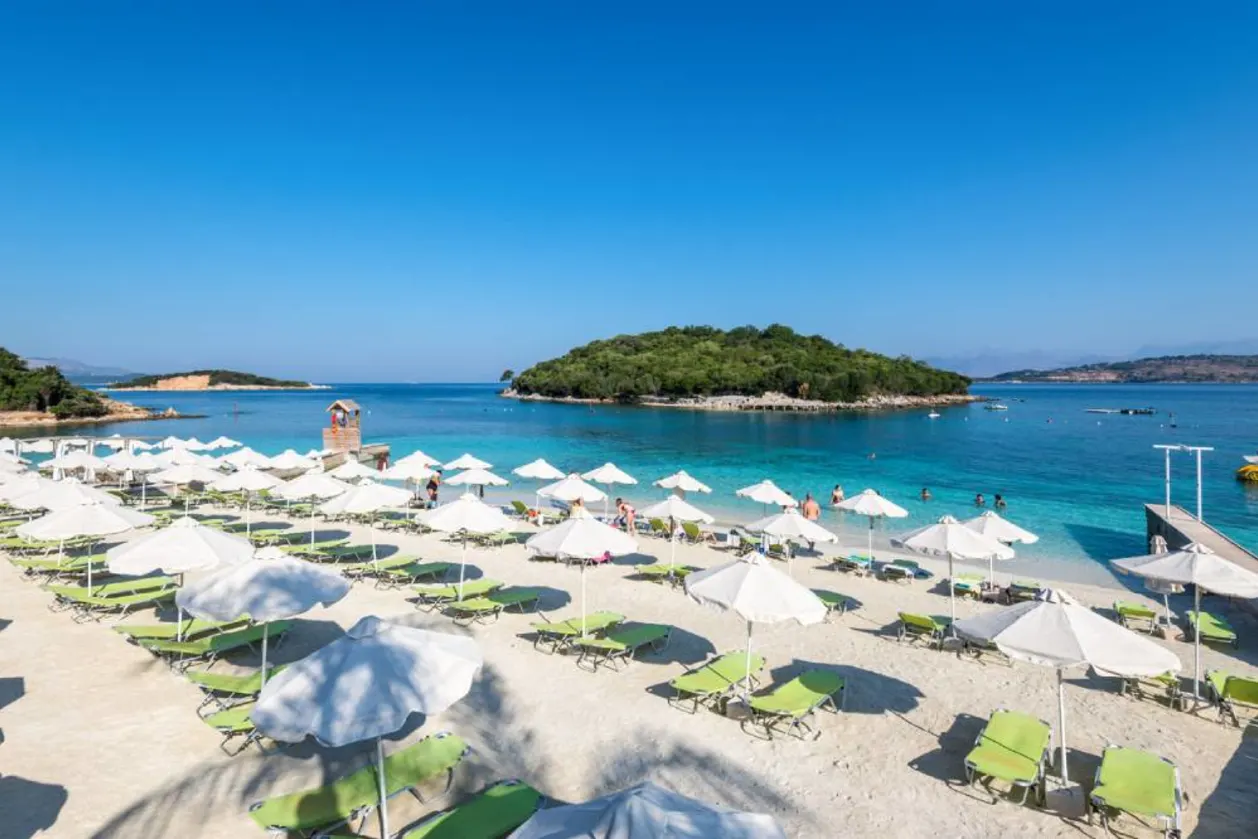 Sunbeds and people on Ksamil Albania beach